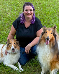 Ren Meyer kneeling with two dogs
